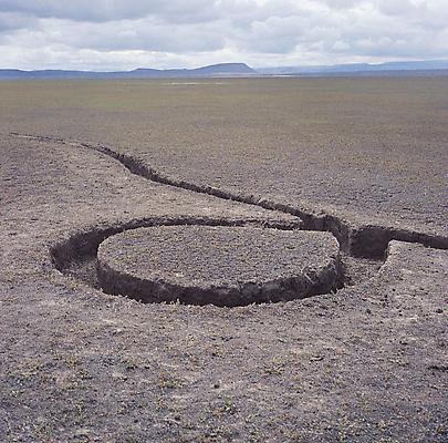 Michael Heizer, "Isolated Mass / Circumflex," 1968 (deteriorated). #9 of Nine Nevada Depresssions. 6 ton displacement in playa surface, 12 x 12 x 1 feet. Location: Massacre Dry Lake, Vya, Nevada Image